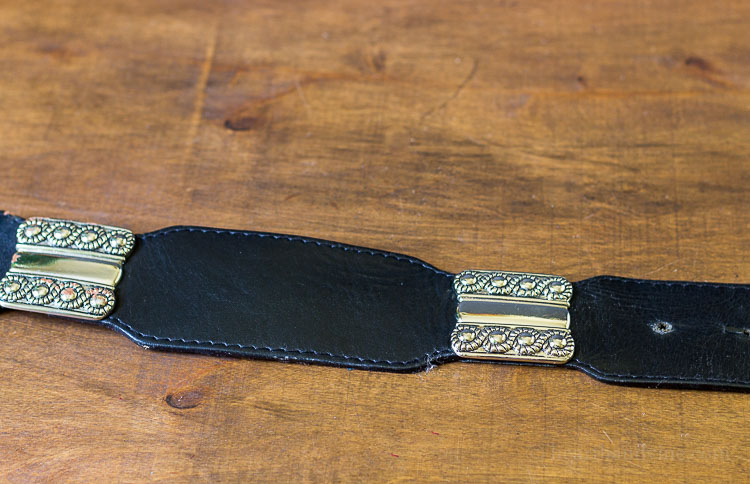 Black leather belt with silver metal sections.