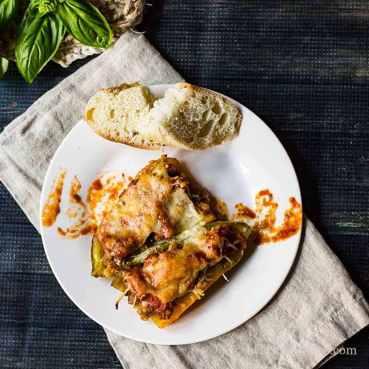 Plate of Italian stuffed peppers with a side of bread