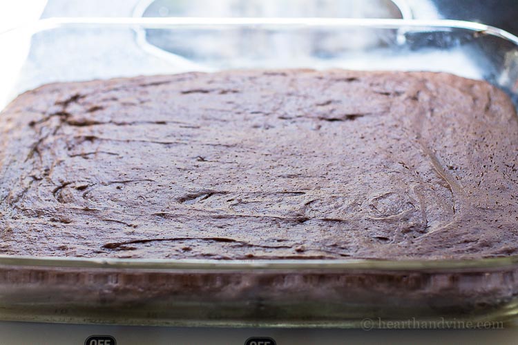 Box chocolate cake layer in a glass baking pan.