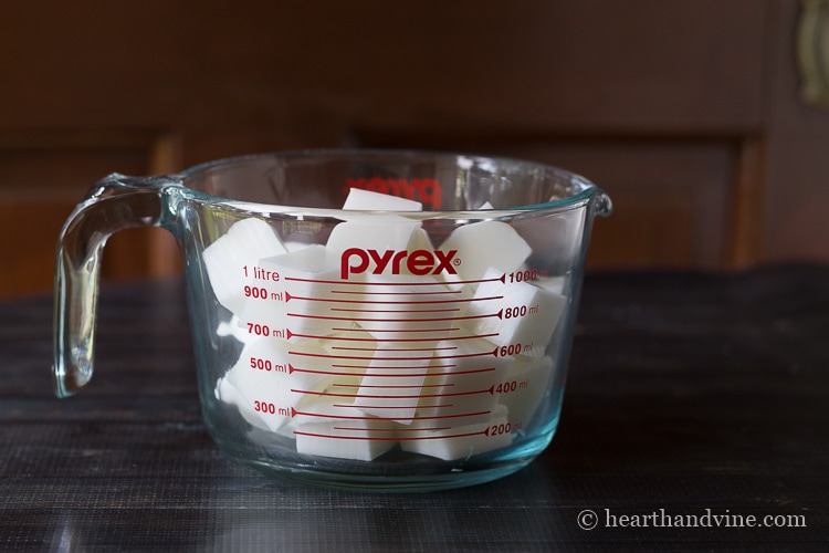 Melt and pour soap base cubed in glass measuring cup