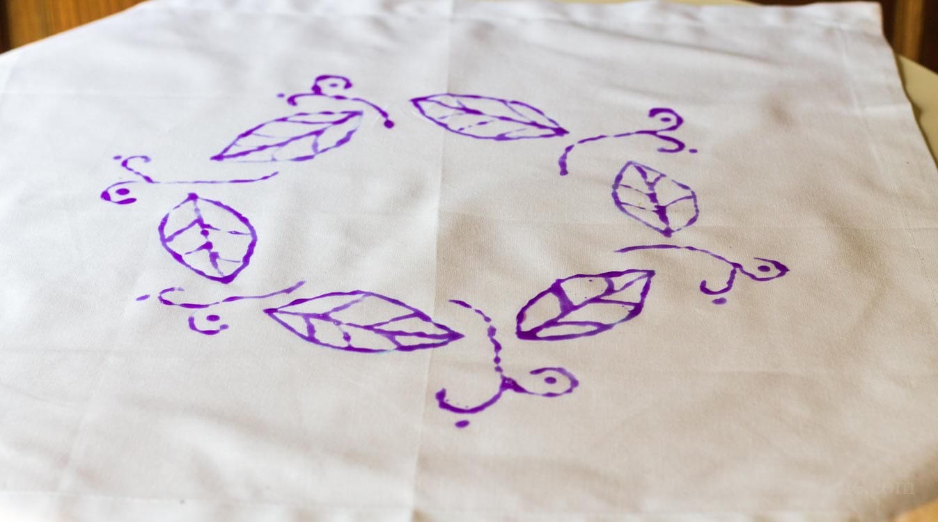 Batik fabric art using purple liquid glue for the pattern.
