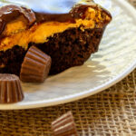 Serving of chocolate and peanut butter cake with peanut butter cups.