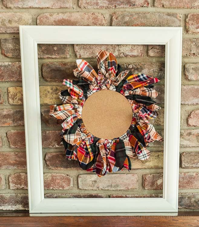 This embroidery hoop upcycled wreath is easy to make with old flannel shirts that you may have on hand or can buy at your local thrift store.