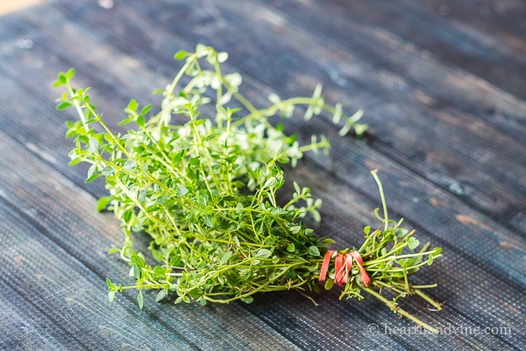 A bunch of thyme held together with a rubber band.