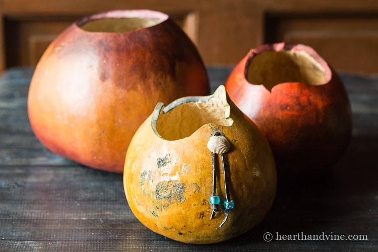 Old gourds that were cut at the top to create a bowl and painted.