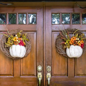 A pumpkin wreath made with half a pumpkin that acts as a vase for faux flowers is a great way to add beautiful fall color to your front door.