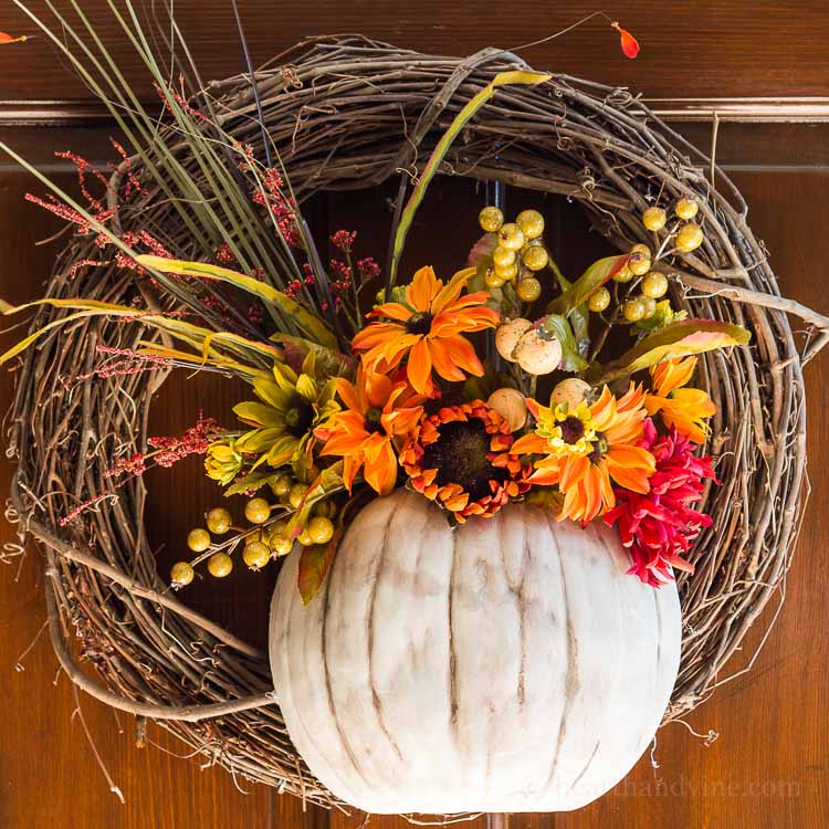 A floral pumpkin wreath perfect for a front door in the fall.