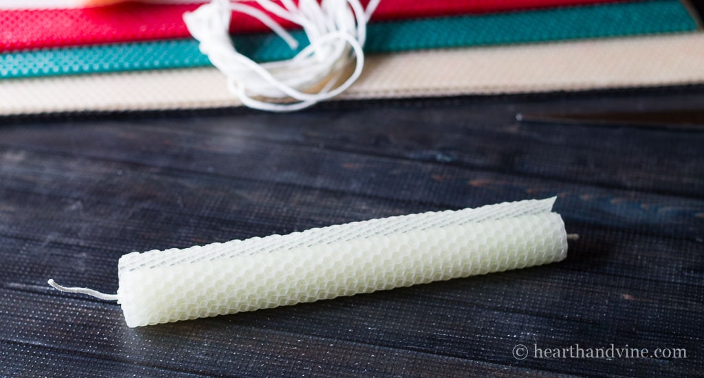 Rolled beeswax taper candles edge.