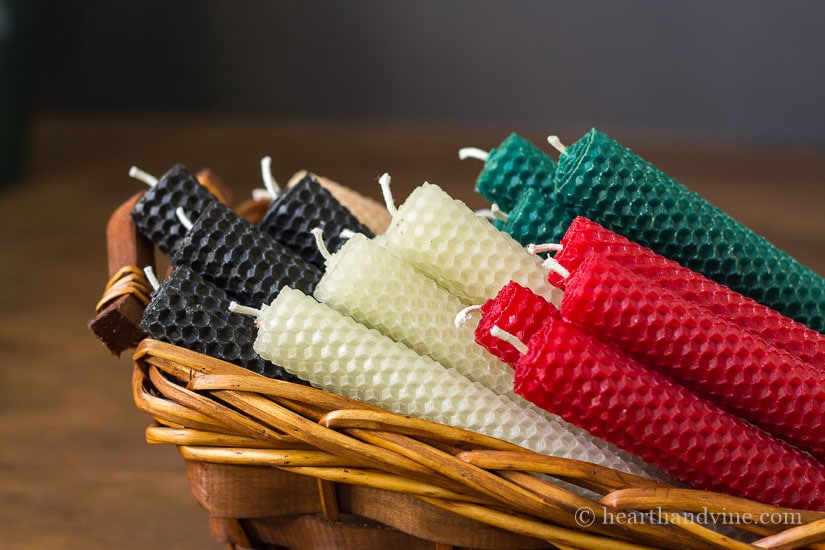 Rolled beeswax candle pairs in a basket.