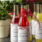 Cranberry simple syrup bottles with red bows.