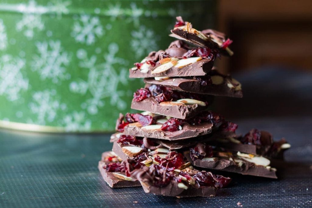 Chocolate bark candy with almond and dried cranberries.