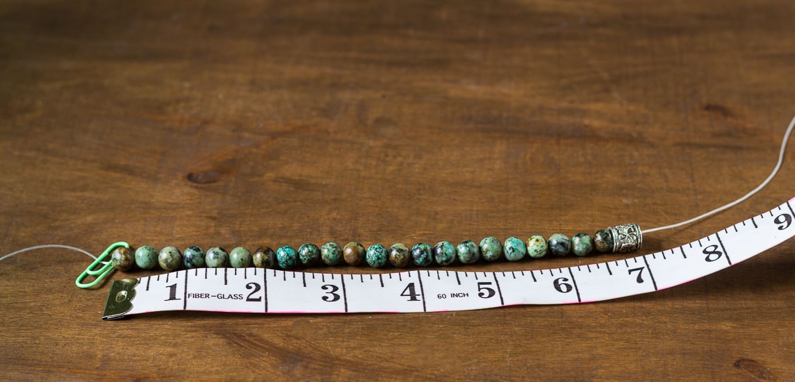 Healing stone bracelets threading beads to length.