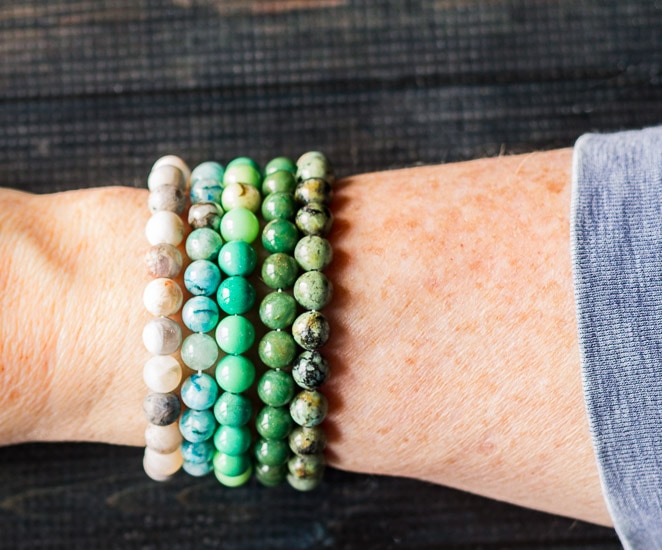 Healing stone bracelets on arm.