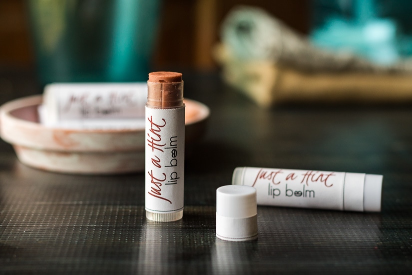 Tinted lip balm tubes called Just a Hint lip balm.