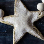 Large white salt dough star edged with gold.