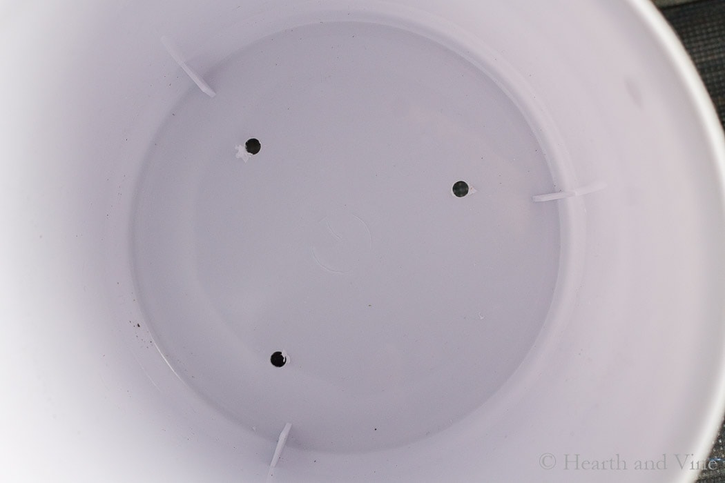 Holes drilled in the bottom of white can