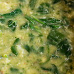 close up image of cauliflower and spinach soup.