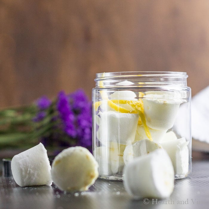 Shower steamers on the table and in a jar with lemon peel.