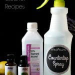 Bottles of essential oils, isopropyl alcohol and a large spray bottle.