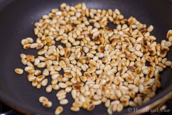 Toasting pine nuts in a pan