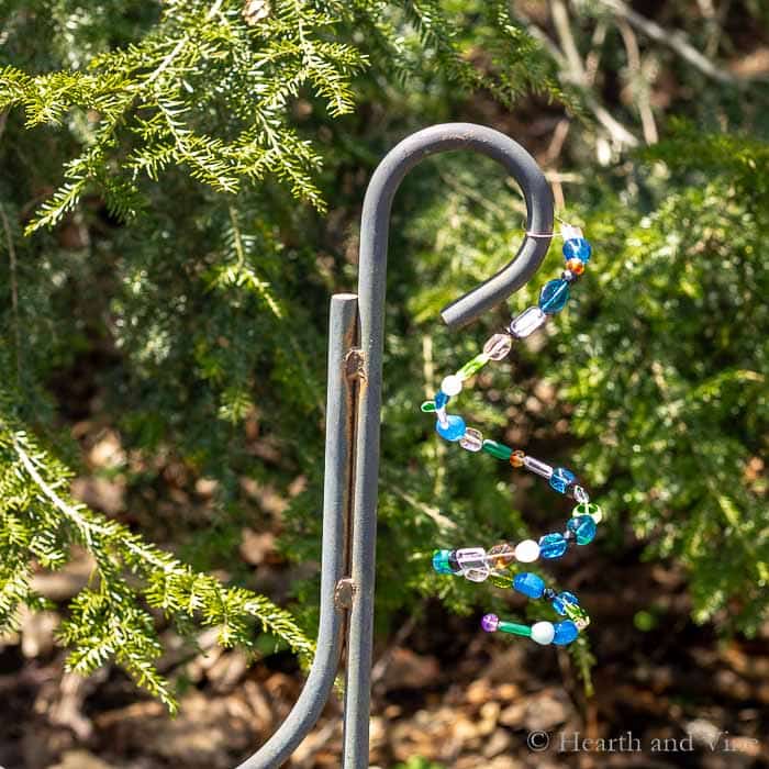 Beaded garden ornaments hanging on shepherd's hook