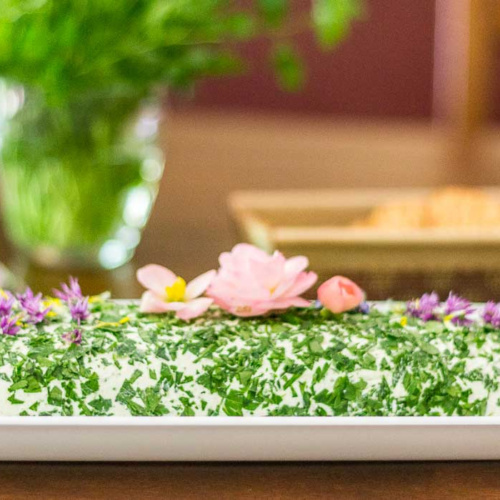 Herb cheese spread with edible flowers.