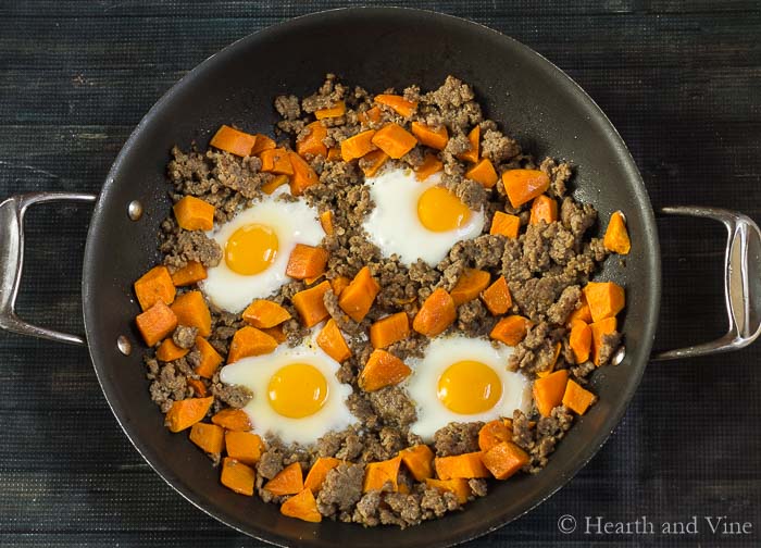 Sweet potato sausage egg fry up in pan