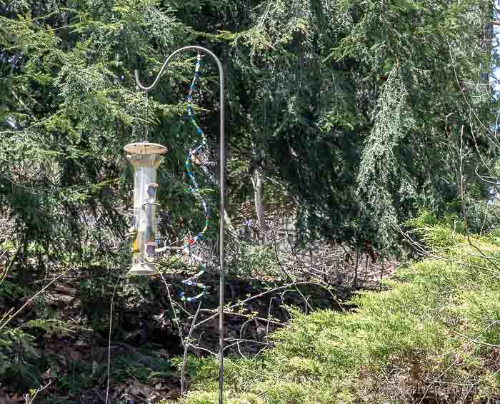 Beaded garden ornaments on bird feeder