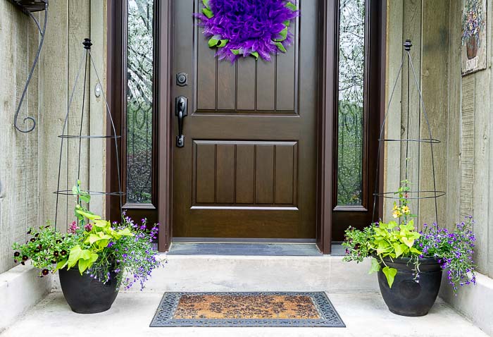 Flower pot trellis planters flanking front door.