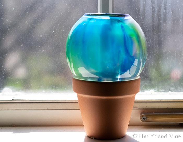 Dried small gazing ball on window sill.