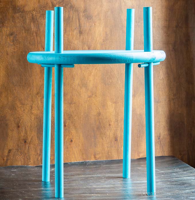 Completed outdoor wooden plant stand painted light blue.
