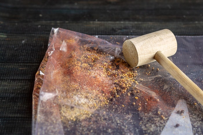 Spices in a bag with mallet
