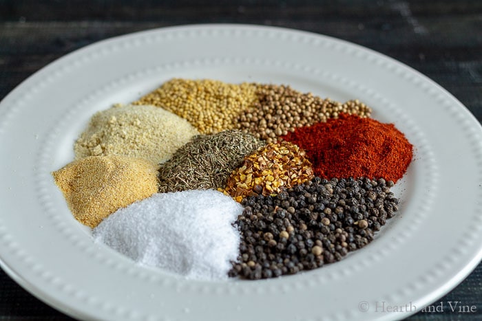 Nine different spices on a dish.