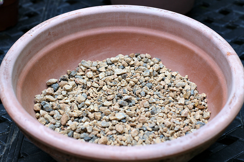 Gravel in bottom of terra cotta pot