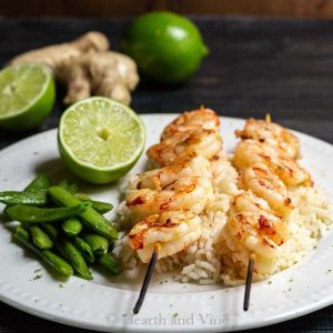 Plate of ginger lime shrimp on rice with snap peas