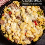 Cast iron skillet with pasta cheese ground beef onions and peppers