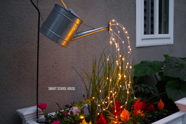 Watering can lights garden art.