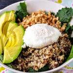 Power grain bowl with quinoa, farrow, avocado, egg, and kale