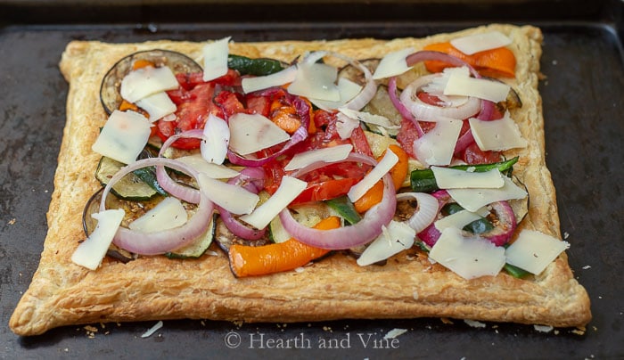 Grilled vegetables and cheese on puff pastry dough base.