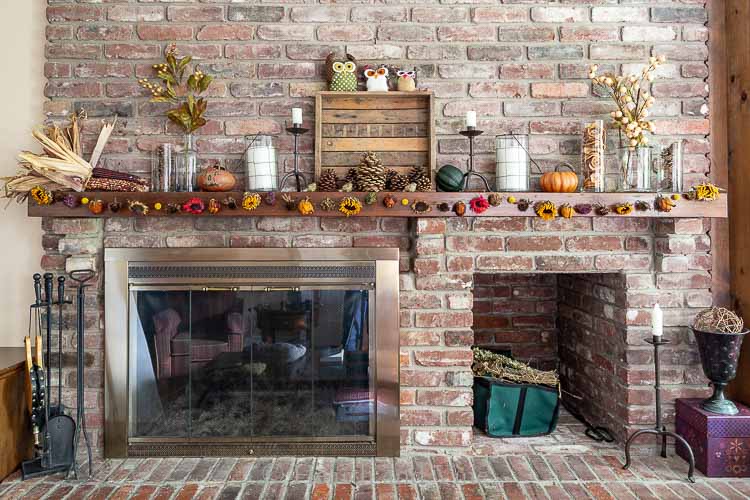 Family room mantel decorated for fall with dried flower garland