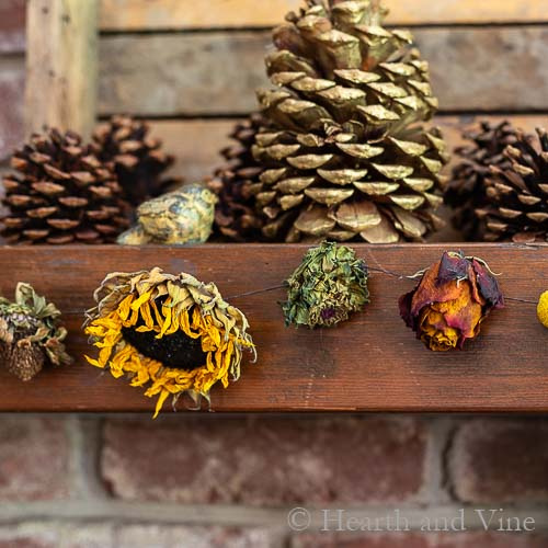 Dried flower garland partial view on a mantel.