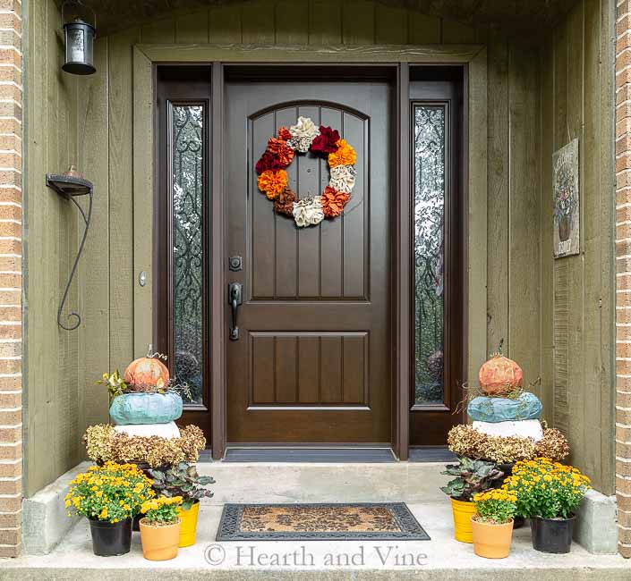 Front porch fall decor with pumpkin topiary