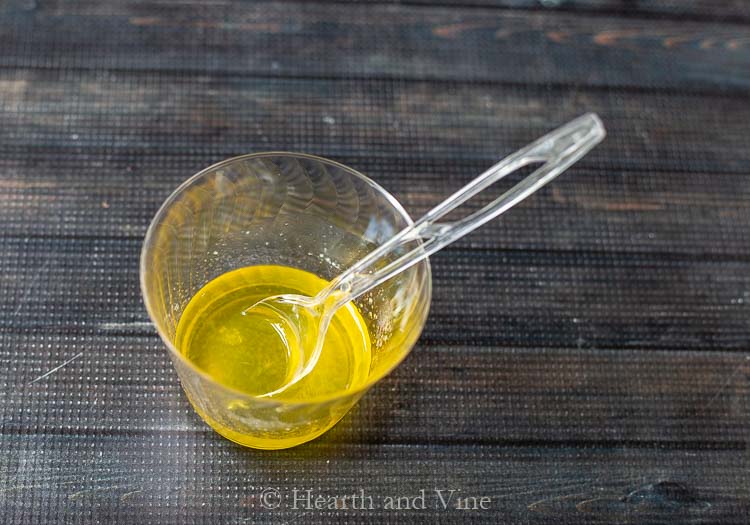 Cup with melted beeswax and oil