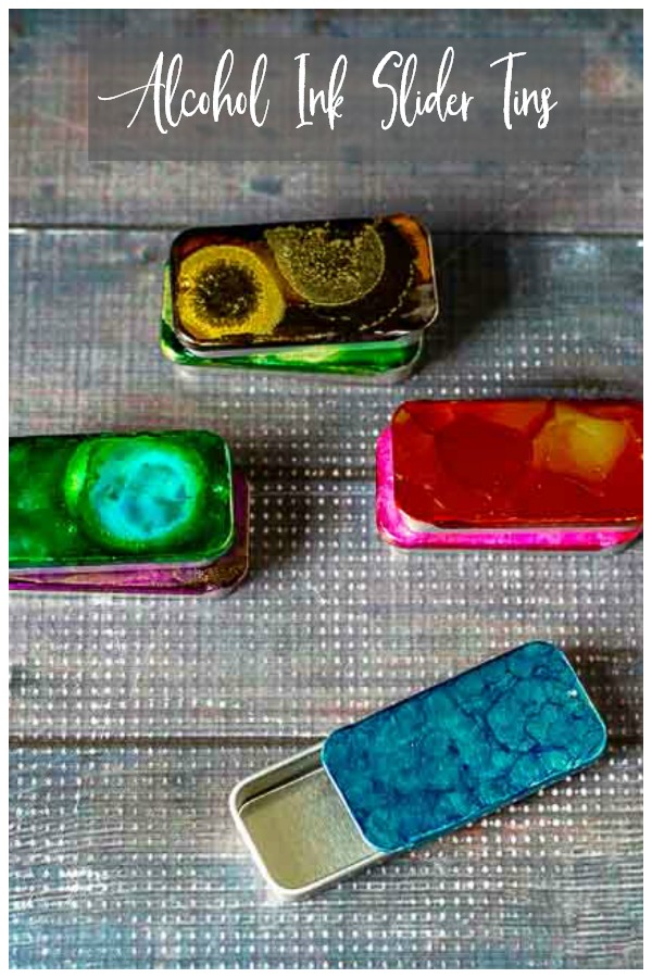 4 slider tins decorated with alcohol inks