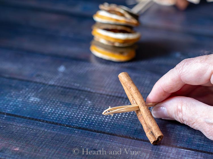 Threading raffia through cinnamon stick