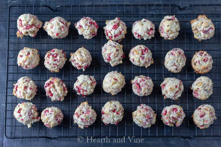 Fresh cranberry pistachio cookies on drying rack.