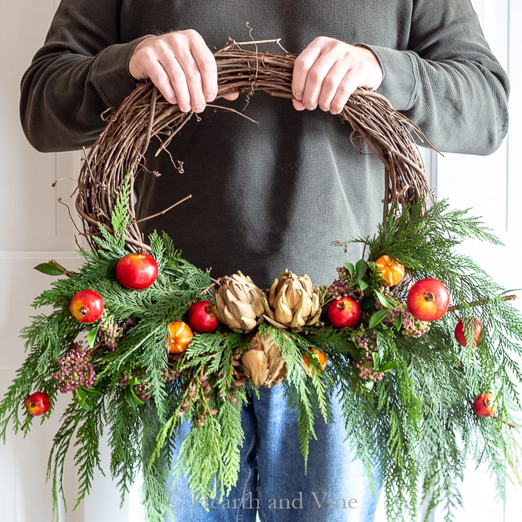 Winter wreath with fresh and faux materials