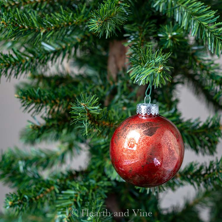 Red and gold alcohol ink ornament.