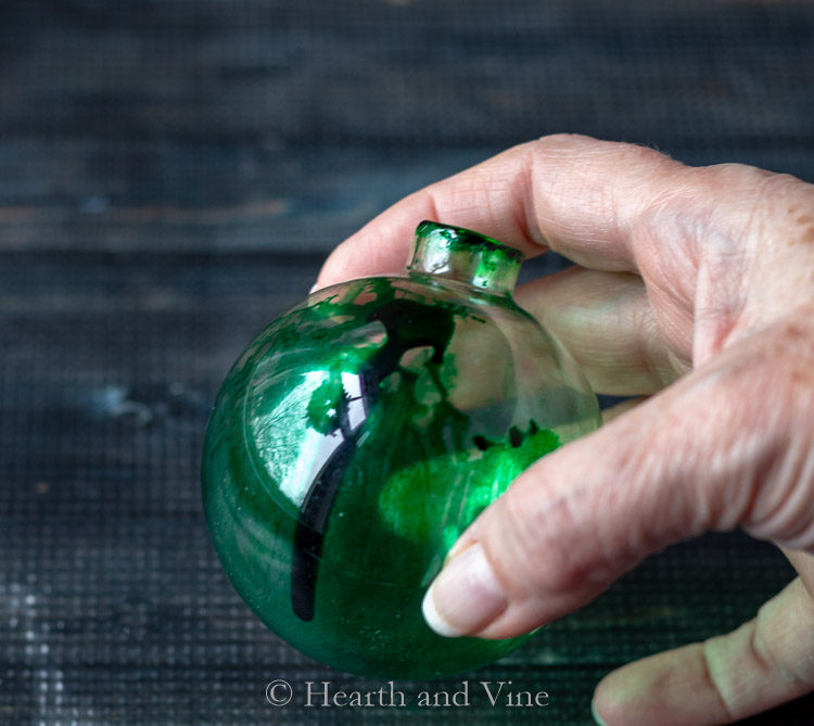 Ornament with green alcohol ink not spreading well.