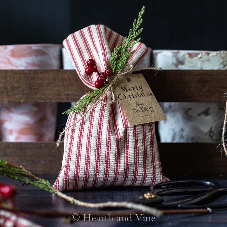 Christmas treat bag decorated with greens and berries